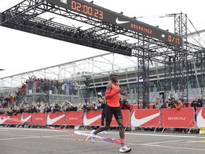 Olympic marathon champion Eliud Kipchoge crosses the finish line at the Monza Formula One racetrack on Saturday, May 6, 2017. He finished 25 seconds shy of making history in the first attempt to break the two-hour marathon mark.