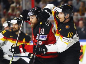 Canada's Ryan O'Reilly does battle with Christian Ehrhoff of Germany during a quarterfinal at the 2017 IIHF world hockey championship on May 18, 2017 in Cologne, Germany. Canada won 2-1.