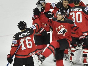 Canada's Colton Parayko gives a high five to Mitch Marner after winning a 4-2 victory over Russia in the semifinals at the world hockey championship in Cologne, Germany on Saturday, May 20, 2017.