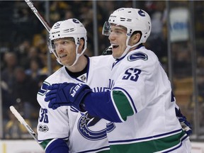 Vancouver Canucks' Bo Horvat (53) celebrates his goal with teammate Jannik Hansen (36) during the first period of an NHL hockey game against the Boston Bruins on Saturday, Feb. 11, 2017.