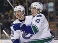 Vancouver Canucks' Bo Horvat (53) celebrates his goal with teammate Jannik Hansen (36) during the first period of an NHL hockey game against the Boston Bruins on Saturday, Feb. 11, 2017.