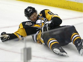Pittsburgh Penguins centre Sidney Crosby lies on the ice after taking a hit from Washington Capitals defenceman Matt Niskanen on May 1.