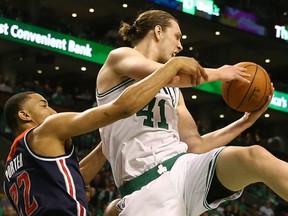 Canadian Kelly Olynyk, right, of the Boston Celtics goes high to snare a rebound from Otto Porter of the Washington Wizards during Monday's Game 7 of their Eastern Conference semifinal in Boston. Olynyk, who was born in Toronto but grew up in Kamloops, B.C., had 26 points as the Celtics posted a 115-105 victory to advance against the Cleveland Cavaliers in the Eastern Conference Finals.