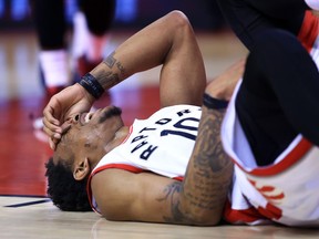 Toronto Raptors guard DeMar DeRozan lies on the court after being fouled against the Cleveland Cavaliers on May 7.