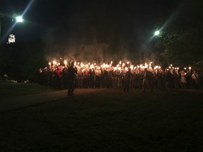 With a Gen. Robert E. Lee statue in the background, people gather at Lee Park in Charlottesville, Va., to protest the plans to remove the monument.