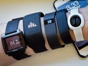 Fitness trackers, from left, Basis Peak, Adidas Fit Smart, Fitbit Charge, Sony SmartBand, and Jawbone Move, are posed.