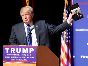 Donald Trump holds up a copy of his 1987 book, The Art of the Deal, early in his presidential campaign.