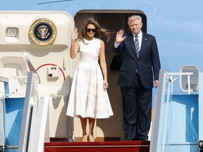 U.S. President Donald Trump and First Lady Melania Trump wave goodbye as they board Air Force One at Ben Gurion International Airport in Tel Aviv, prior to their departure for Rome on May 23, 2017.