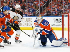 Edmonton Oilers' goaltender Cam Talbot knocks down a shot with defenceman Matthew Benning trying to fend off Ducks' Nate Thompson during Game 3 action in the Western Conference semifinal Sunday in Edmonton. The Ducks were 6-3 winners to cut the Oilers' series lead to 2-1.