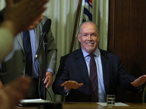 B.C. NDP leader John Horgan delivers opening remarks to the New Democrat caucus before reviewing the agreement during a press conference at Legislature in Victoria, B.C., on Tuesday, May 30, 2017.