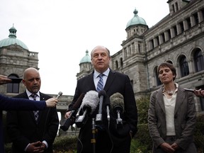 B.C. Green party leader Andrew Weaver is joined by elected party members Adam Olsen and Sonia Furstenau to speak to media in the rose garden on the Legislature grounds in Victoria, B.C., on Wednesday, May 10, 2017.