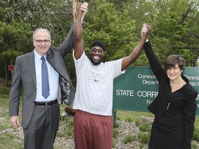 Shaurn Thomas, center, poses for a photo with attorneys James Figorski and Marissa Bluestine of the Pennsylvania Innocence Project after leaving the Frackville Correctional Institution on Tuesday, May 23, 2017, in Frackville, Pa.