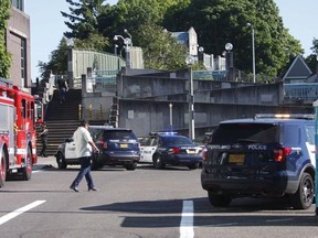 Police investigate a deadly stabbing on a Metropolitan Area Express train in northeast Portland, Ore., Friday, May 26, 2017.