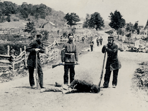 Canadian militiamen stand over the body of a Fenian killed in the 1870 Battle of Eccles Hill.