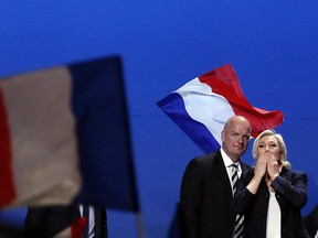 French far-right presidential candidate Marine Le Pen, flanked with her body guard Thierry Legier, blows kisses to supporters at the end of her meeting, Monday May 1, 2017, in Villepinte, outside Paris.