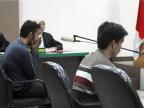 Two men, accused of having sex in contravention of sharia law, appear in court in Banda Aceh.