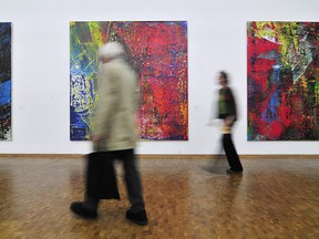 In a 2008 file photo, exhibition visitors walk past paintings by German artist Gerhard Richter in Cologne. Richter has opened his retrospective exhibition at Prague's National Gallery.