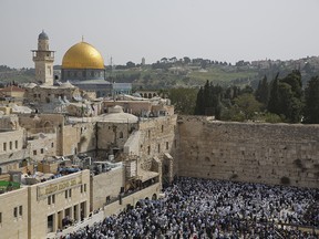 In this photo taken April 13, 2017, Jewish men of the Cohanim priestly caste participate in a blessing during the Passover holiday in front of the Western Wall, the holiest site where Jews can pray in Jerusalem's Old City.