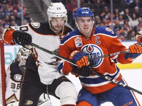 In this April 1 file photo, Edmonton Oilers forward Connor McDavid (right) battles Anaheim Ducks forward Antoine Vermette.