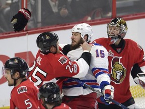 Ottawa Senators right wing Chris Neil (left) drops the gloves and throws a punch at New York Rangers winger Tanner Glass on May 6.