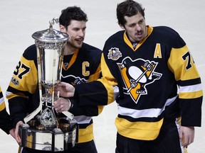 Pittsburgh Penguins forwards Sidney Crosby (left) and Evgeni Malkin pose with the the Prince of Wales Trophy on May 25.