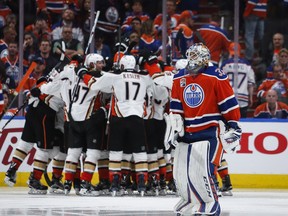 Anaheim Ducks players celebrate their victory as Edmonton Oilers goalie Cam Talbot, right, skates past during overtime NHL hockey round two playoff action in Edmonton, Wednesday, May 3, 2017.