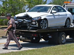 The damaged vehicle is moved after an 89-year-old man died after crashing into a fire hydrant in Viera, Fla.
