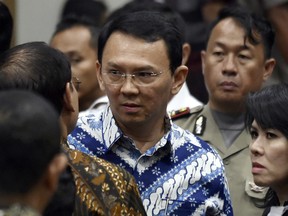 Jakarta Governor Basuki "Ahok" Tjahaja Purnama, centre, talks to his lawyers after his sentencing hearing at a court in Jakarta, Indonesia on Tuesday, May 9, 2017. An Indonesian court on Tuesday sentenced the minority Christian governor to two years in prison for blaspheming the Koran.
