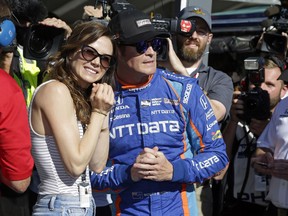 Scott Dixon, of New Zealand, watches with his wife, Emma, the final attempt to knock him off the pole during qualifications for the Indianapolis 500 IndyCar auto race at Indianapolis Motor Speedway, Sunday, May 21, 2017, in Indianapolis.