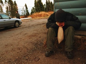 An unidentified Sheshatshiu Innu youth openly sniffs gas in the community on Friday Nov. 17, 2000.