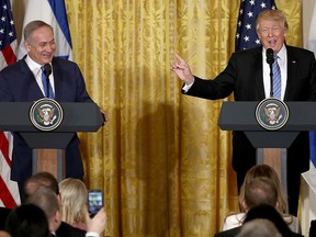 U.S. President Donald Trump (R) and Israel Prime Minister Benjamin Netanyahu (L) answer questions during a joint news conference in the East Room of the White House February 15, 2017 in Washington, DC.