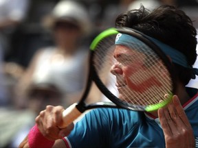 In this May 19 file photo, Milos Raonic returns a ball to Alexander Zverev at the Italian Open in Rome.