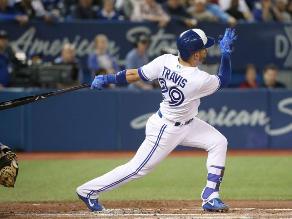 Toronto Blue Jays' Devon Travis hits an RBI single during the