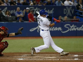 Troy Tulowitzki of the Toronto Blue Jays unloads with a grand slam homer in the third inning of Monday's MLB game against the Cincinnati Reds at Rogers Centre. The Jays scored 17 runs on 23 hits in a 17-2 rout of the Reds.