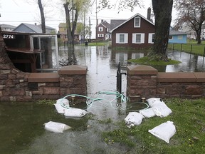 In this May 2, 2017 file photo, floodwaters from Lake Ontario fill a yard along Edgemere Dr., in Greece, N.Y.