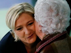 French far-right presidential candidate, Marine Le Pen is greeted after casting her ballot in Henin Beaumont, France on Sunday.