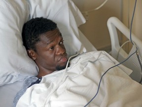 Murder suspect Bampumim Teixeira lies in a hospital bed at Tufts Medical Center in Boston on Monday, May 8, 2017. He has been accused of murdering two engaged doctors in their South Boston penthouse condominium.