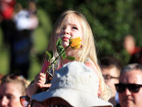 Ruby Tindall watches from her father's shoulders during a vigil to commemorate the victims of the May 22 attack on Manchester Arena.
