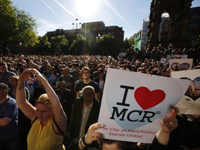 Crowds gather for a vigil in Albert Square, Manchester, England, Tuesday May 23, 2017, the day after the suicide attack at an Ariana Grande concert that left 22 people dead.