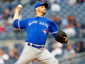 Marco Estrada delivers a pitch against the New York Yankees during MLB action Monday night at Yankee Stadium. Estrada pitched seven complete innings in compiling his first victory of the season as the Jays prevailed 7-1 to give them three straight victories.