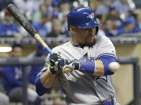 Russell Martin of the Toronto Blue Jays takes a pitch off his left elbow during MLB action Tuesday against the Milwaukee Brewers in Milwaukee. The Jays hung on to post a 4-3 victory.