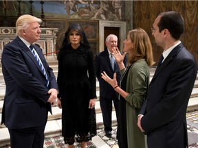 President Donald Trump and his wife Melania listen to a guide during their visit to the Sistine Chapel and the Vatican Museums on May 24, 2017.