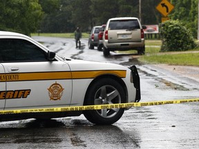 A Lincoln County Sheriff's vehicle and evidence tape block a street Sunday, May 28, 2017, in Brookhaven, Miss., where several people were fatally shot Saturday evening. A man was arrested Sunday in the house-to-house shooting rampage that left several people dead, including a sheriff's deputy.
