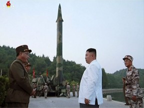 North Korean leader Kim Jong Un and a missile launcher in North Korea