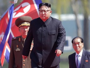 In this April 13, 2017 file photo, North Korean leader Kim Jong Un, center,  is accompanied by Pak Pong Ju, right, Hwang Pyong So, second left, as he arrives for the official opening of the Ryomyong residential area, in Pyongyang, North Korea.