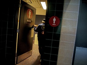 Tom McDonald walks into the men’s restroom at Citi Field in New York, April 14, 2017.