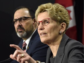 Ontario Premier Kathleen Wynne, right, speaks as Ontario Energy Minister Glenn Thibeault looks on during a press conference in Toronto on Thursday, March 2, 2017.