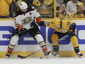 Ryan Kesler, left, of the Anaheim Ducks and Viktor Arvidsson of the Nashville Predators, battle for a loose puck along the boards during Game 6 action in the Western Conference final Monday in Nashville. The Preds won 6-3 to take the series 4-2 and advance to the Stanley Cup final for the first time in franchise history.