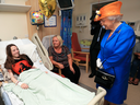 Queen Elizabeth II speaks to Millie Robson, 15, and her mother, Marie, as she visits the Royal Manchester Children's Hospital in Manchester England, to meet victims of the terror attack in the city earlier this week. Marie was wearing an Ariana Grande T-shirt.