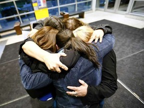 The five daughters of a sexual assault victim hug at Calgary Courts after the guilty verdict of Wayne Howard Bernard was handed down on Wednesday May 17, 2017.